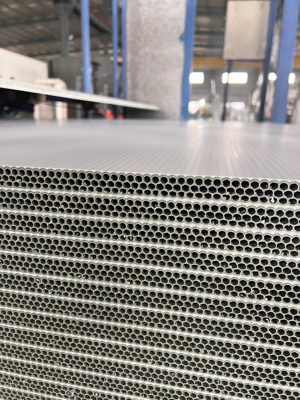 Close-up of a hollow plastic panel core at the production site