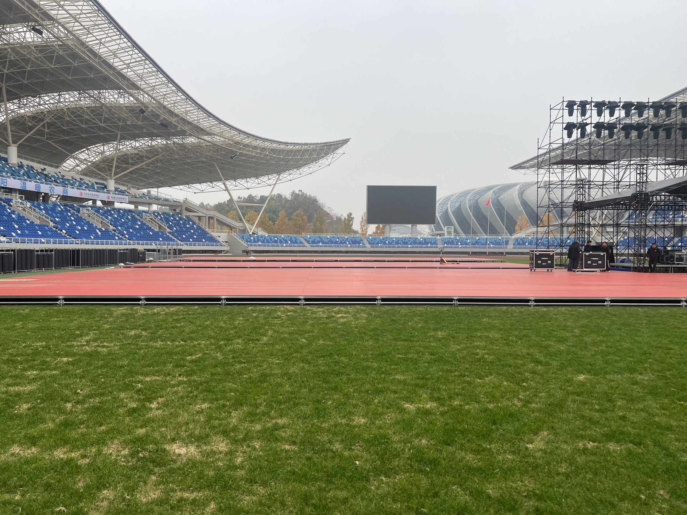 Temporary stage-panel installation in a stadium